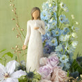 Willow Tree With sympathy, 9”h hand-painted standing resin figure in cream dress, holding white dove on hand, nestled in floral bouquet