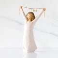Front view: figure in cream dress holding gold chain above her head with year 2025 on it