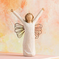Willow Tree Courage, 6”h hand-painted standing resin angel figure in cream dress with wire wings, both arms upraised, in front of orange painting