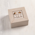 Cream wood box with hinged lid. Inset bas-relief plaque of two seated girls, facing each other.