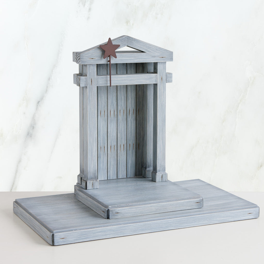 Grey barn standing up on stand with brown star on it