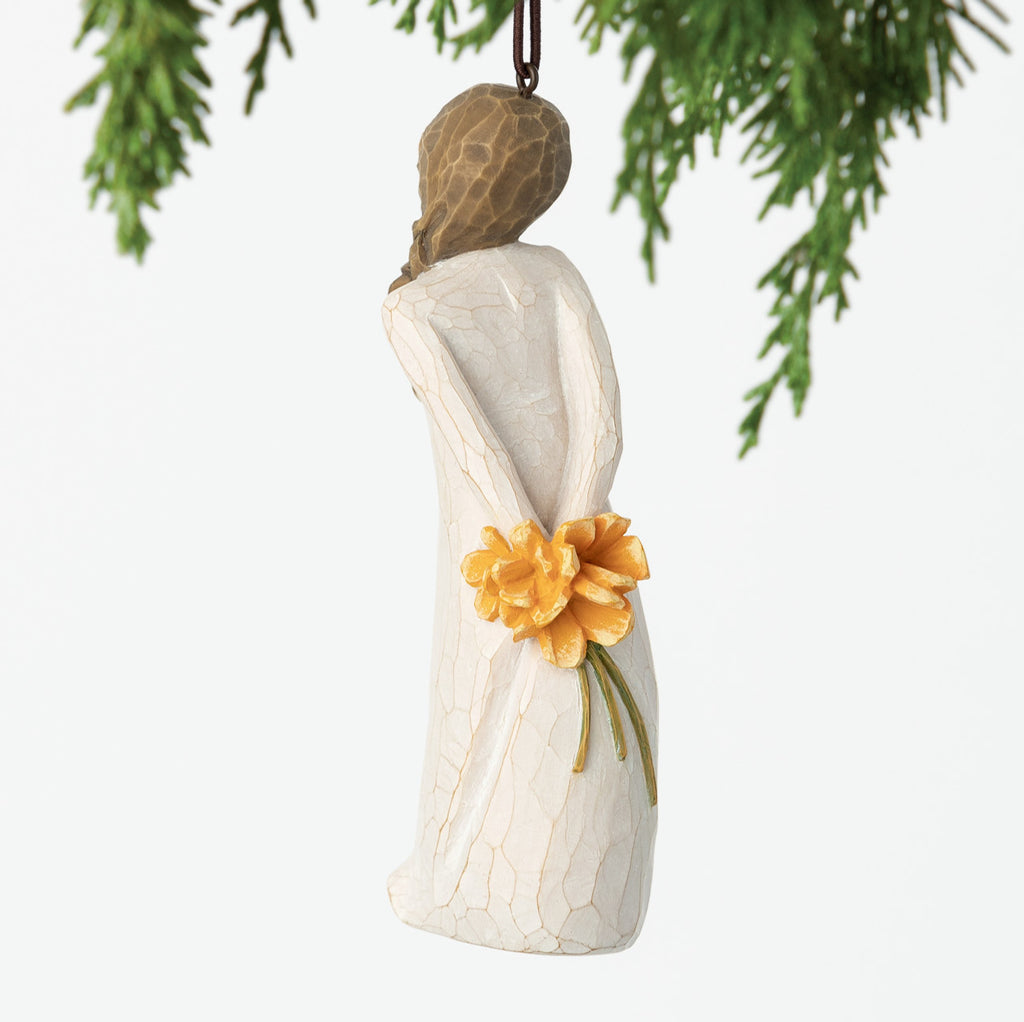 Back view, female figure in cream dress, holding bouquet of orange flowers behind back. Hook and loop affixed to head