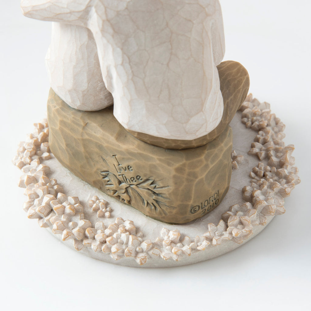 Close view of round white plaque with golden rock on top