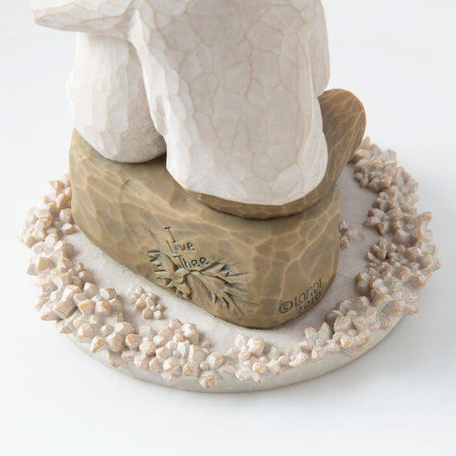 Close view of round white plaque with golden rock on top