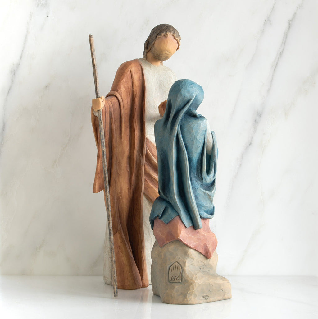 Nativity scene figurines facing forward - man is wearing brown, woman is wearing blue