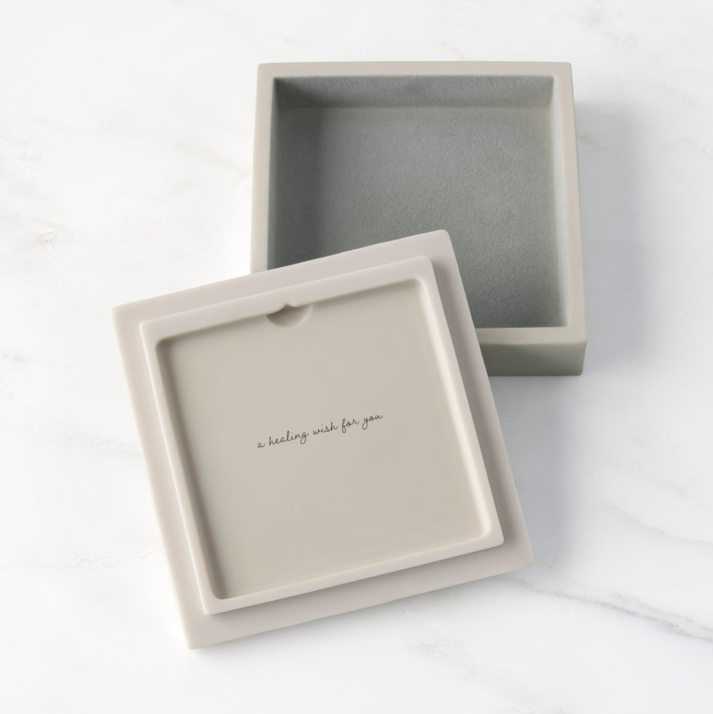 White resin box with detached lid showing sentiment on lid back; velvety gray-green finish in box base