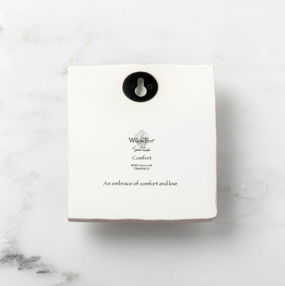 Back of white plaque reading piece title and sentiment, with Willow Tree logo