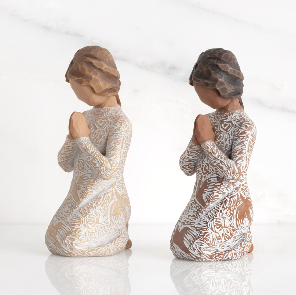 Lighter &amp; Darker skin Kneeling figures, hands in position of prayer or meditation in cream dress carved with icons of nature, lighter and darker skin versions