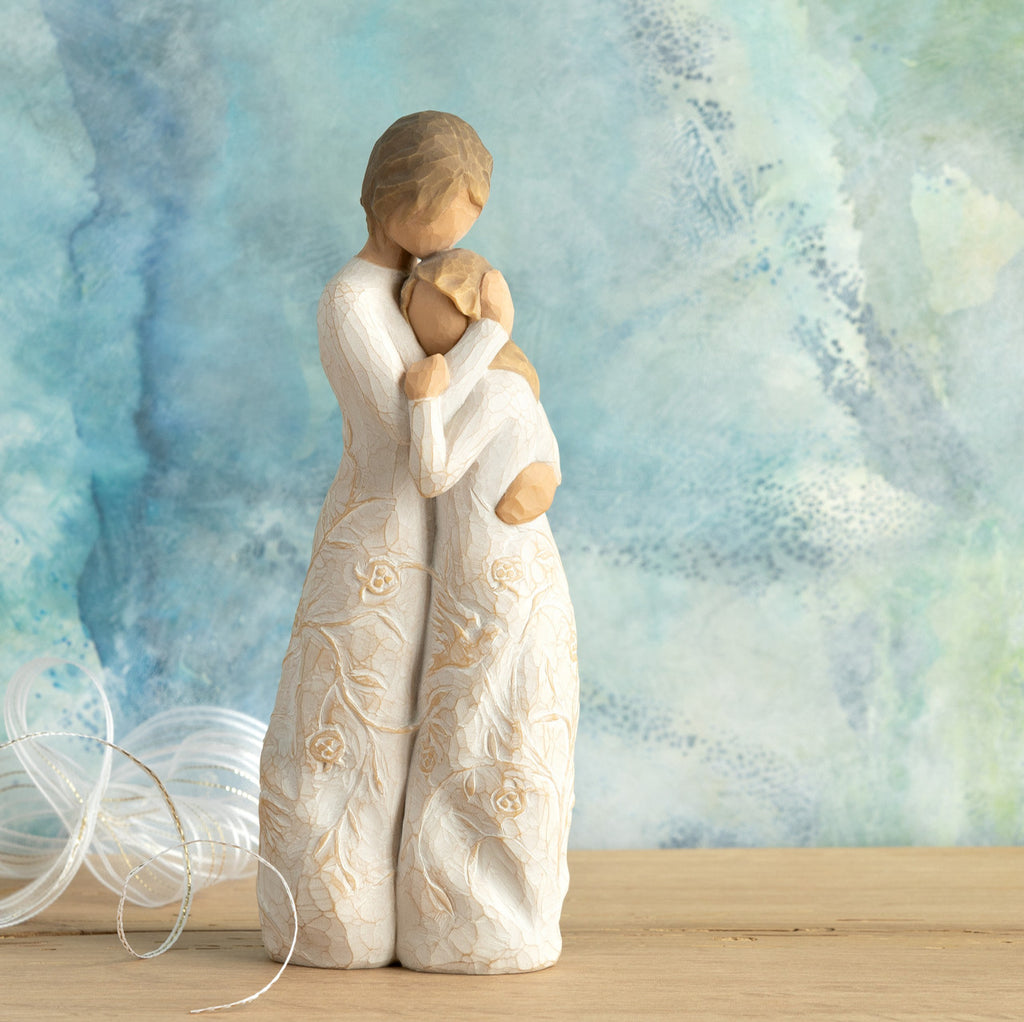 Willow Tree Close to me, 8"h hand-painted standing resin figure of woman embracing tween girl, both in cream dresses carved with intertwined vines and leaves, in front of blue painting