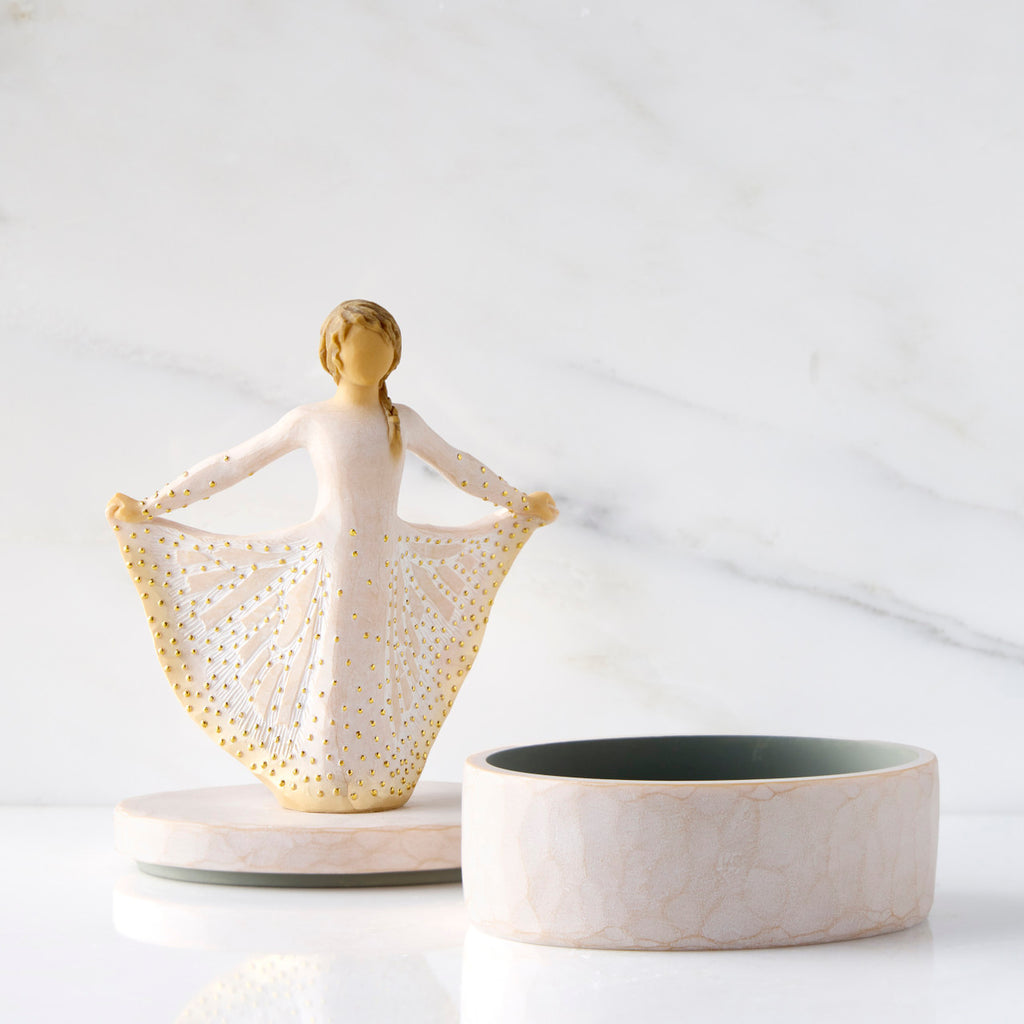 Front view: open oval resin box, showing detached lid with figure next to box base