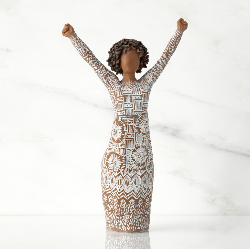 Front view of figure with natural hairstyle, arms raised overhead, dress etched with African textile patterns