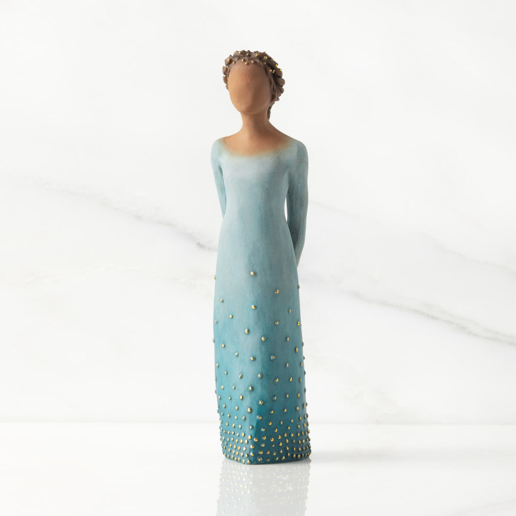 Facing front: Darker-skin figure, arms clasped behind back, hair and deep blue ombré garment dotted with gold leaf